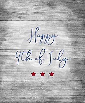 Happy 4th of July sign in blue letters with red stars on wood background photo