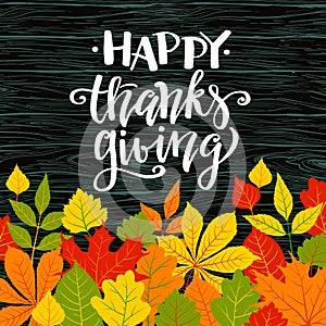 Happy Thanksgiving, autumn holyday background, maple and oak leaves on wooden background, hand written lettering,