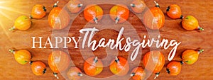 Happy Thanksgiving background banner panorama - Colorful autumnal orange pumpkins on brown rustic wooden table texture, top view,