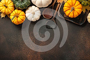 Happy Thanksgiving background with decorative pumpkins and vintage wooden spoons