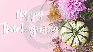 Happy Thanksgiving Card. Happy thanksgiving text, pumpkins, dahlias, leaves, heather on pink background flat lay. Season`s