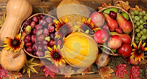Happy Thanksgiving concept, fall background with seasonal fall berries, pumpkins, melons, apples, grapes and flowers on wooden