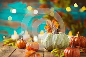 Happy Thanksgiving concept pumpkin decor on wooden table over festive background. Autumn season greeting card