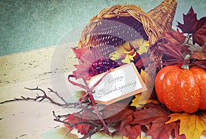 Happy Thanksgiving cornucopia with Autumn Fall leaves