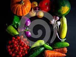 Happy Thanksgiving Day background, black wooden table decorated with pumpkins and autumn vegetables. Harvest festival. Colorful