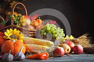 Happy Thanksgiving Day background, wooden table decorated with Pumpkins, Maize, fruits and autumn leaves. Harvest