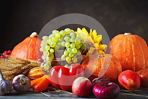 Happy Thanksgiving Day background, wooden table decorated with Pumpkins, Maize, fruits and autumn leaves. Harvest