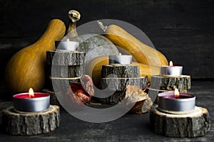 Happy Thanksgiving Day, Decoration on a wooden table with Burning Candles and Pumpkins, Corncob, autumn leaves in the background