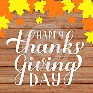 Happy Thanksgiving Day modern calligraphy brush lettering with fall maple leaves on rustic wood background. Easy to edit vector