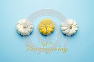 Happy Thanksgiving Day with pumpkin and nut on blue background