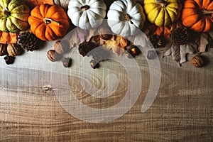 Happy Thanksgiving Day with pumpkin and nut on wooden table