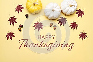 Happy Thanksgiving Day with pumpkin and nut on yellow background