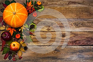 Happy Thanksgiving decor with fall leaves on wooden background