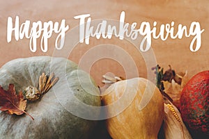 Happy Thanksgiving greeting card. Hand written Happy Thanksgiving text on background of pumpkins, autumn leaves, nuts, harvest