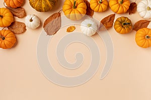 Happy Thanksgiving holiday background from autumn foliage and pumpkins top view. Harvest, halloween, autumn and fall composition