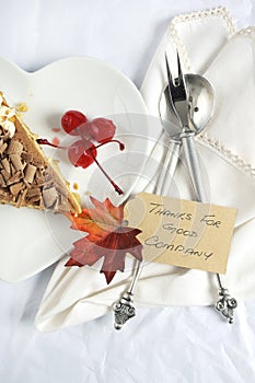 Happy Thanksgiving place setting on white table - vertical closeup.