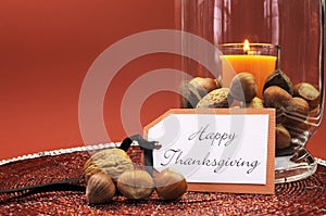 Happy Thanksgiving table setting centerpiece with ornage candle and nuts