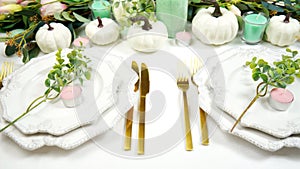 Happy Thanksgiving table setting with modern white pumpkins centerpiece.