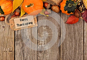 Happy Thanksgiving tag with autumn top border over wood