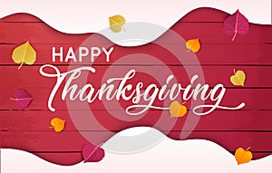 Happy Thanksgiving text with  leaves over red wood background