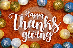 Happy Thanksgiving text and LED cotton Balls Decoration on orange Glitter background