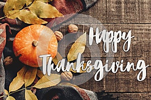 Happy thanksgiving text sign flat lay. pumpkin with leaves and