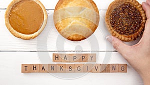 Happy Thanksgiving on a White Wood Table with Various Pies