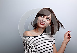 Happy thinking flirting young woman with short hairstyle lookin photo