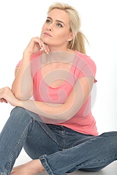 Happy Thoughtful Attractive Young Woman Sitting on the Floor Relaxing