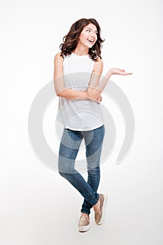 Happy thoughtful woman holding copyspace on the palm