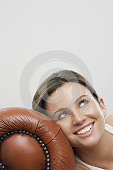 Happy Thoughtful Woman Relaxing On Sofa's Armrest