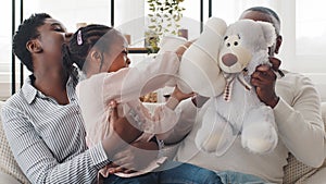 Happy three generation afro american family at home play with teddy bears close-up portrait. Little black girl daughter