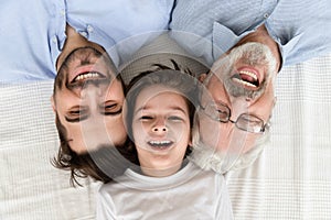 Happy three generation family lying in row, portrait, closeup view