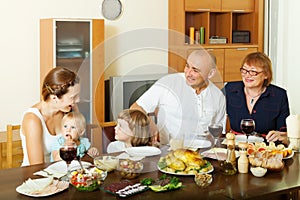 Happy three generations family over dining table at home