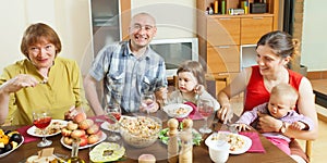 Happy three generations family posing over celebratory table