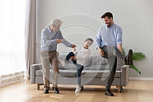 Happy three generations of men dancing together