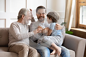 Happy three generations of men have fun at home