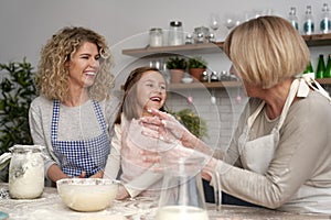 Happy three generations of women in the kitchen during Easter