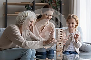 Happy three generations of women play at home together photo