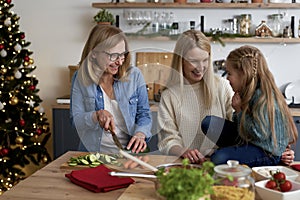 Happy three generations women spending time in the kitchen