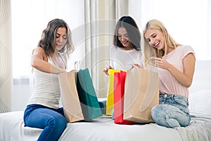 Happy three girls with many shopping bags