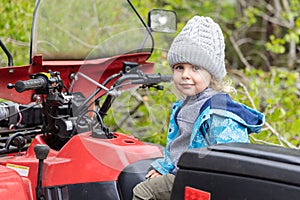 Portrait of young boy on quad bike