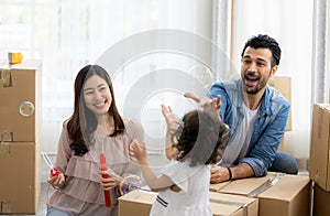 Happy time family blow soap bubbles relax in living room. Everyone having fun in the house