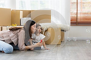 Happy time family blow soap bubbles relax in living room. Everyone having fun in the house