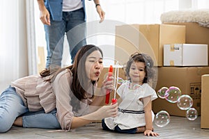 Happy time family blow soap bubbles relax in living room. Everyone having fun in the house