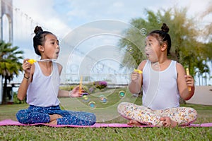 Happy time of friendship , two girl kid sister play soap bubble Smil