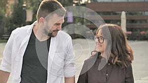 Happy to be together. Rear view of beautiful young couple holding hands and looking at each other with smile while