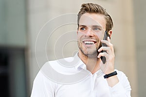 Happy to hear you. Man well groomed speak mobile phone urban background. Businessman cheerful call friend. Friendly