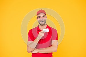 Happy to serve. Man red cap yellow background. Delivering purchase. Discount card. Business contact. Delivered to your