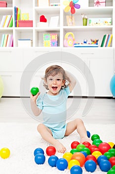 Happy toddler with balls